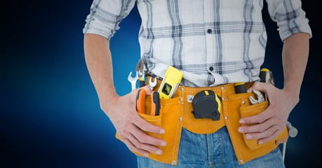Mid section of handyman with tool belt around his waist 