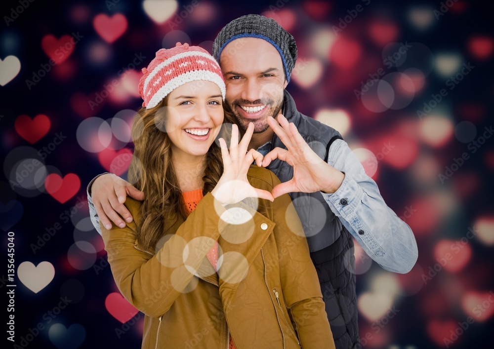 Poster Portrait of smiling couple making heart shape with hands