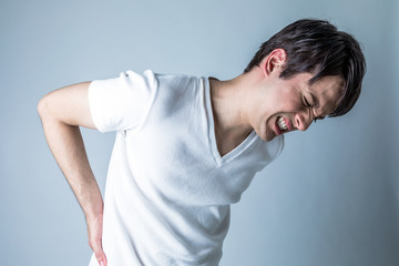 young man having a pain in lower back