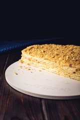 Beautiful cut in half layered Napoleon cake on wooden table