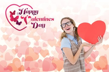 Composite image of love message and nerd woman holding red heart