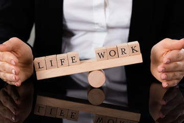 Life And Work Blocks Balancing On Seesaw