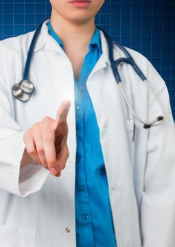 Mid section of female doctor touching virtual screen