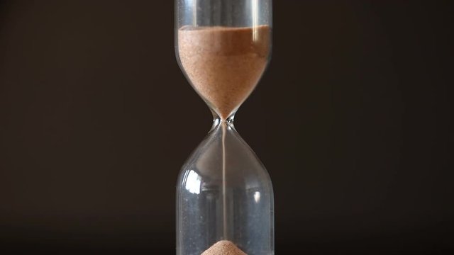 Sand clock closeup on black