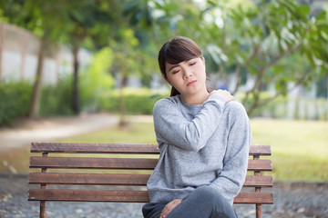 Woman has shoulder pain at park