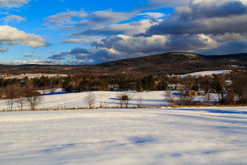 Fototapeta premium Snow covered mountains and village in Brunswick NY