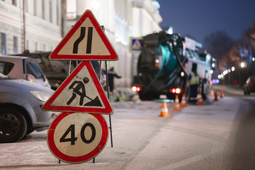 Road warning sign. workers work at night
