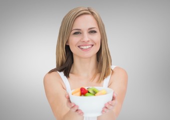 Portrait of beautiful woman holding fruit bowl