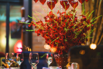 table for event with flower vases, towels and wine glasses