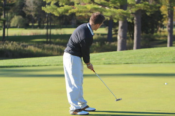 A golfer sinks a long putt for birdie and you can see the ball going right in the center of the hole