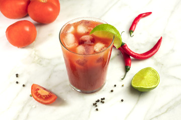 Bloody Mary cocktail with lime, tomatoes and chilis