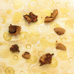 Chocolate macarons crumbs forming frame on golden texture