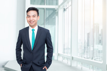 Handsome asian businessman standing in office