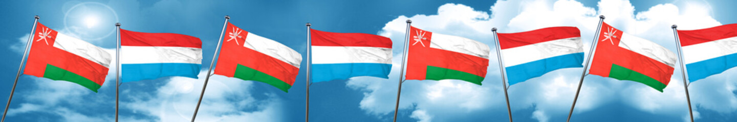 Oman flag with Luxembourg flag, 3D rendering