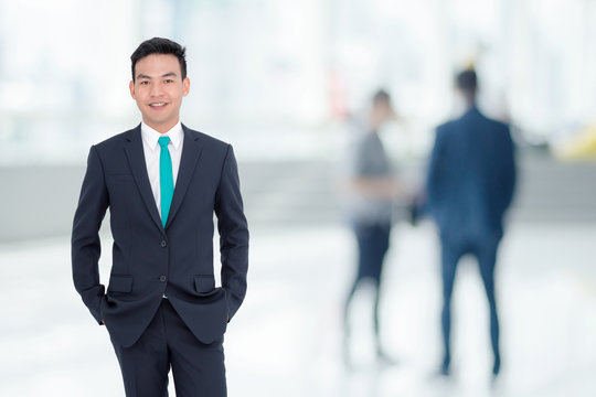 Handsome Asian Businessman Standing In Office