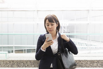 ビジネスウーマン　スマホ　操作　真剣　東京駅