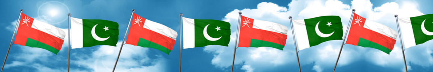 Fototapeta na wymiar Oman flag with Pakistan flag, 3D rendering