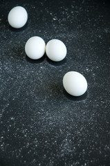 Eggs over black background