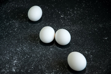 Eggs over black background