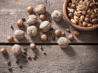 Mixed nuts on old wooden background