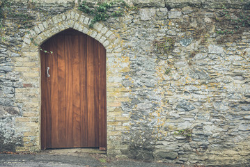 Old stone wall and wooden door