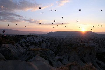 Travel to Goreme, Cappadocia, Turkey. The sunrise in the mountains with a lot of air hot balloons in the sky.