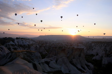 Travel to Goreme, Cappadocia, Turkey. The sunrise in the mountains with a lot of air hot balloons in the sky.