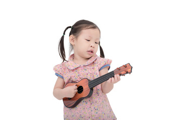 Little asian girl playing guitar toy over white