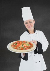 Composite image of smiling female chef with pizza