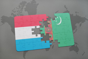 puzzle with the national flag of luxembourg and turkmenistan on a world map