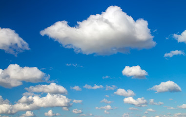 Fototapeta na wymiar Blue sky background with fluffy clouds