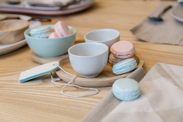 macaron with tea cup set on wooden table with daylight nature st