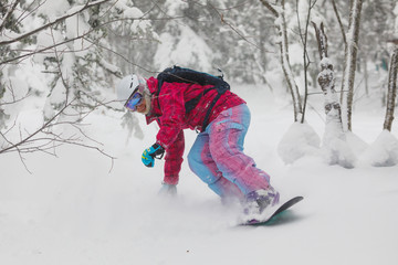 Snowboarder freeride jump in powder.