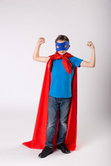Funny superhero child shows his muscle
