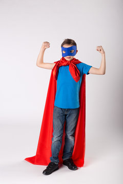 Funny superhero child shows his muscle