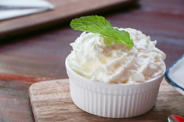 Whipping cream in ceramic cup 