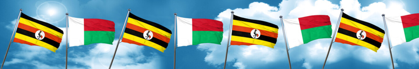 Uganda flag with Madagascar flag, 3D rendering