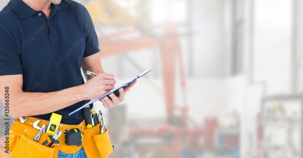 Canvas Prints Mid section of construction man writing on clipboard