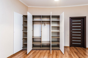 Modern wardrobe with opened doors