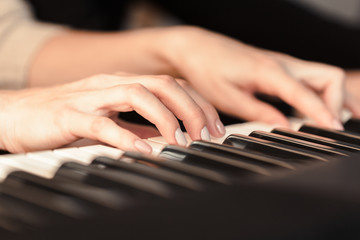 Fototapeta premium Closeup of hands playing piano. Music and hobby concept