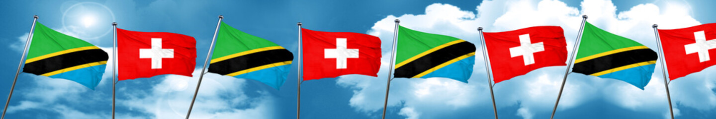 Tanzanian flag with Switzerland flag, 3D rendering