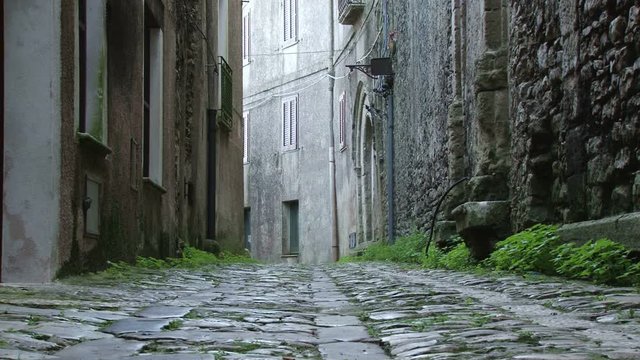 Low angle shot of a deserted, quaint narrow street in Erice, Sicily 