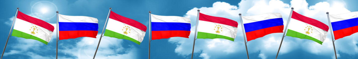 Fototapeta na wymiar Tajikistan flag with Russia flag, 3D rendering