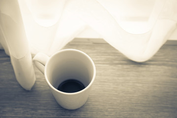 morning white cup coffee with white curtain near window with sun