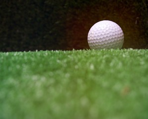 Golf ball is on green grass