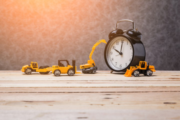 vintage black alarmclock with toy car business construction idea