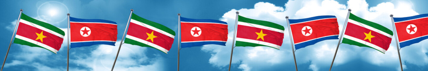 Suriname flag with North Korea flag, 3D rendering