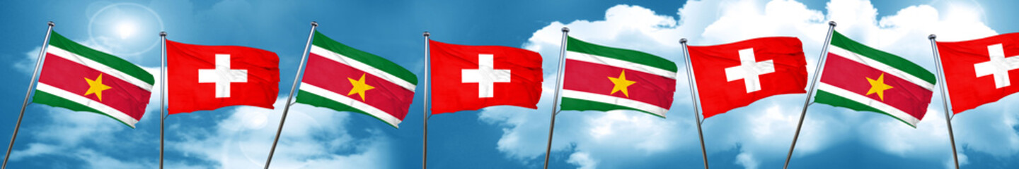 Suriname flag with Switzerland flag, 3D rendering