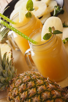 Fresh pineapple juice in a glass jar macro. vertical