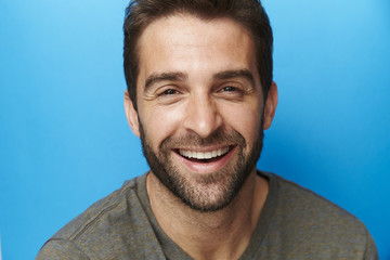 Happy chap in blue studio, portrait